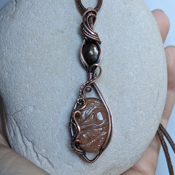 Carved Sunstone & Black Sunstone Wire Wrapped Pendant in Oxidized Copper