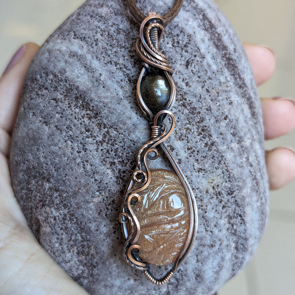 Carved Sunstone & Black Sunstone Wire Wrapped Pendant in Oxidized Copper