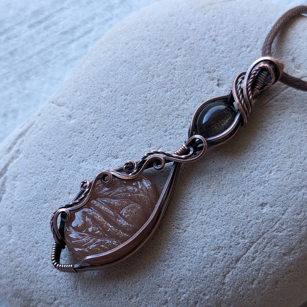 Carved Sunstone & Black Sunstone Wire Wrapped Pendant in Oxidized Copper