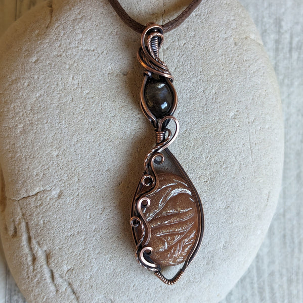 Carved Sunstone & Black Sunstone Wire Wrapped Pendant in Oxidized Copper