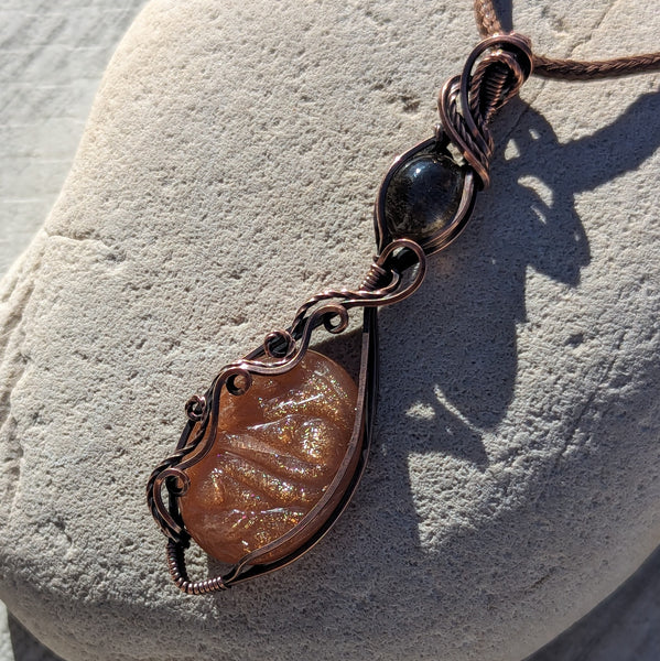 Carved Sunstone & Black Sunstone Wire Wrapped Pendant in Oxidized Copper