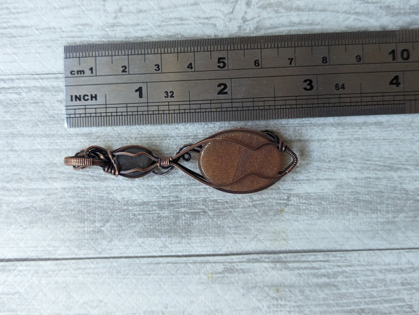 Carved Sunstone & Black Sunstone Wire Wrapped Pendant in Oxidized Copper