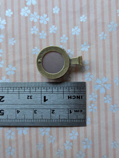 Carved Peach Moonstone Pendant in Antique Brass