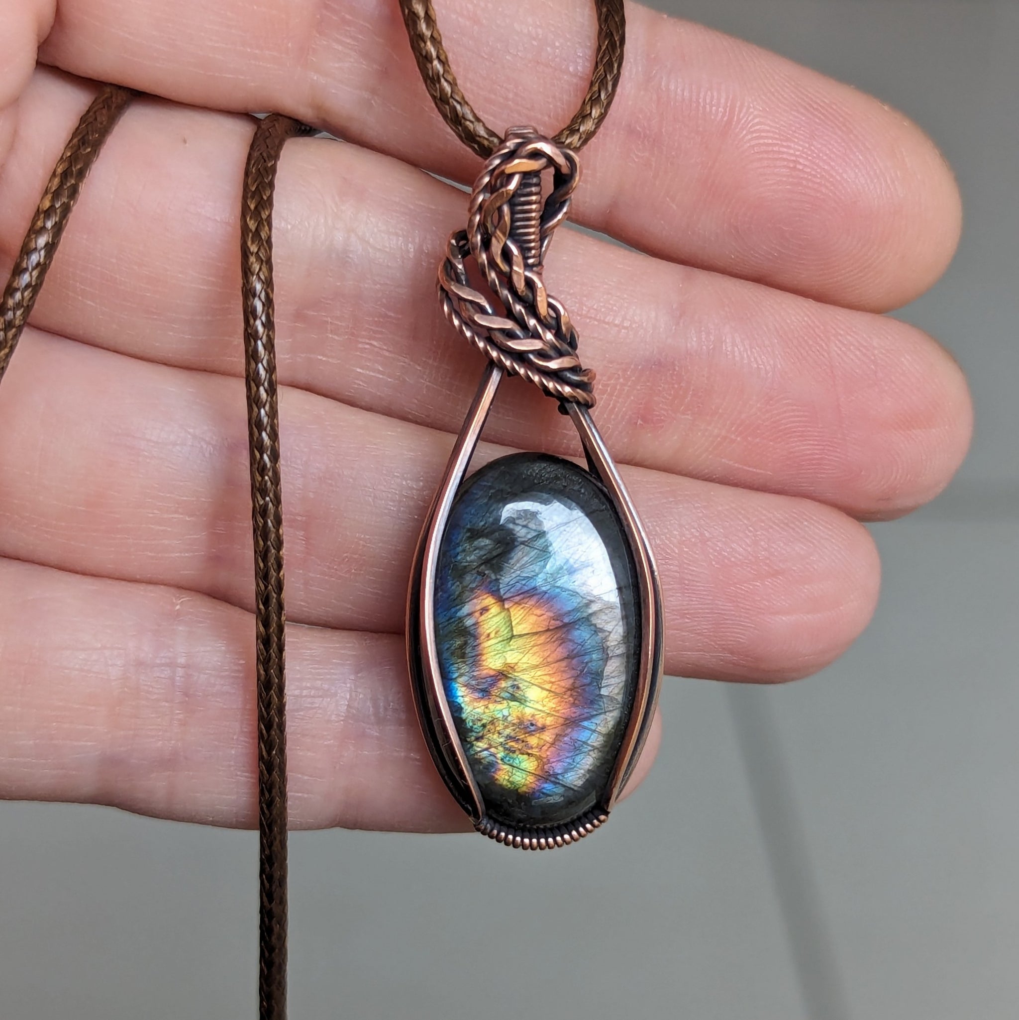 Spectrolite/Labradorite wrapped in oxidized Copper store with Hematite accent